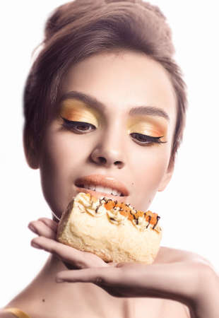 Beautiful fashion girl with delicious orange pralineの写真素材