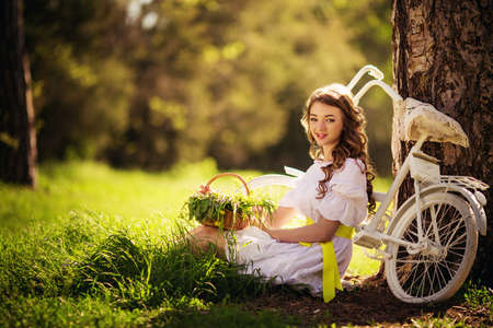 Beautiful young woman in spring gardenの写真素材