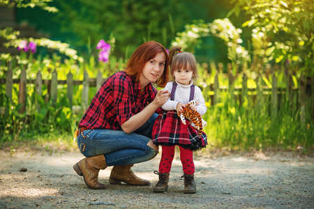 Beautiful mother with baby girl on spring garden