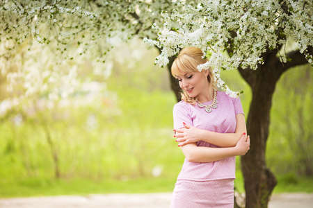 Beautiful young woman in spring gardenの写真素材