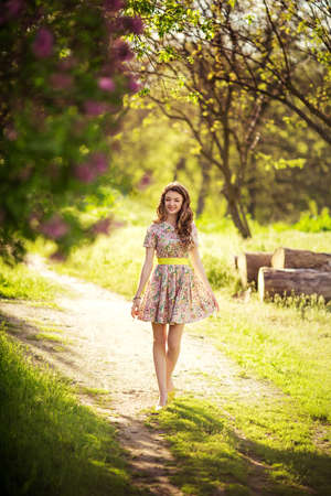 Beautiful young woman in spring gardenの写真素材