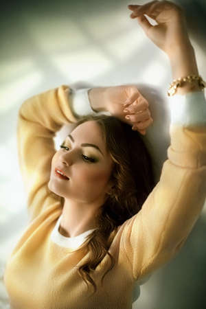 Portrait of beautiful young woman with makeup in fashion clothesの写真素材