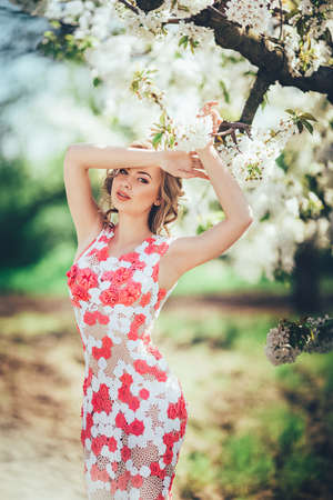 Beautiful young woman in spring gardenの写真素材
