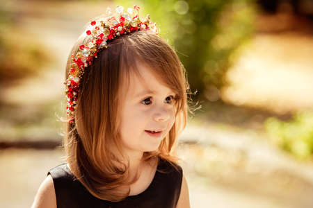 Little happy girl in black-red dressの写真素材