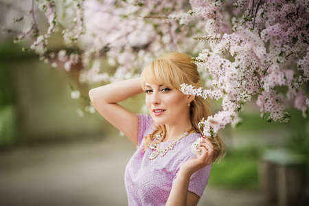 Beautiful young woman in spring garden