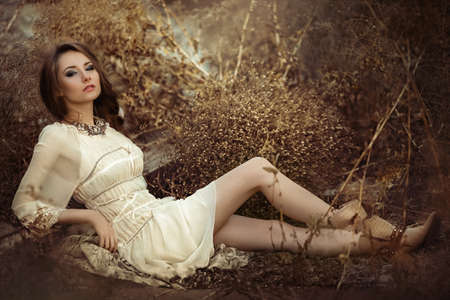 Beautiful girl in autumn gardenの写真素材