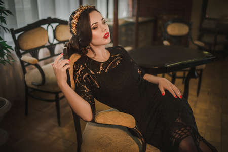 Beautiful woman model with professional makeup, in jewelry. Golden crown in style