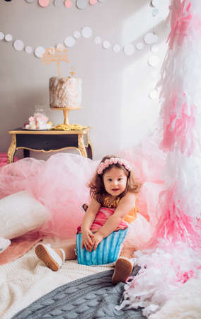 Beautiful little girl celebrating birthday party. Family celebration of the childの写真素材