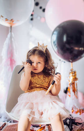 Beautiful little girl celebrating birthday party. Family celebration of the childの写真素材