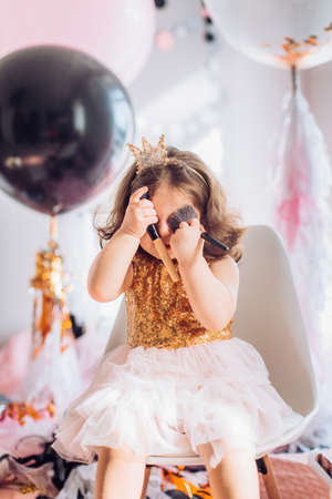 Beautiful little girl celebrating birthday party. Family celebration of the childの写真素材