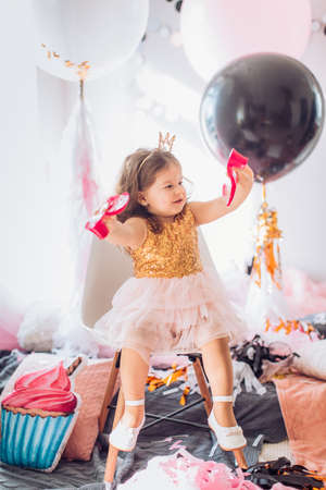 Beautiful little girl celebrating birthday party. Family celebration of the childの写真素材