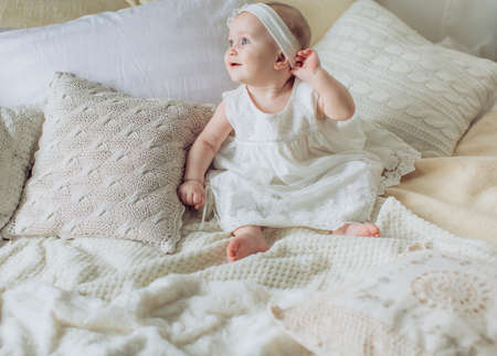 Portrait of a beautiful little girl on the bed