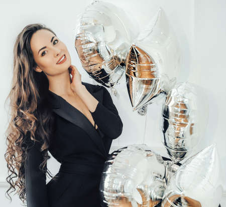 Portrait of beautiful woman air silver ballsの写真素材