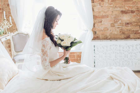 Beautiful bride with stylish make-up in white dressの写真素材