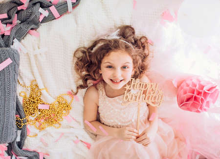 Beautiful little girl celebrating birthday party with big bouncy balls. Family celebration of the childの写真素材
