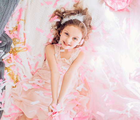 Beautiful little girl celebrating birthday party with big bouncy balls. Family celebration of the...