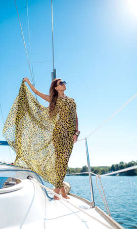 Young sexy woman on her private yachtの写真素材