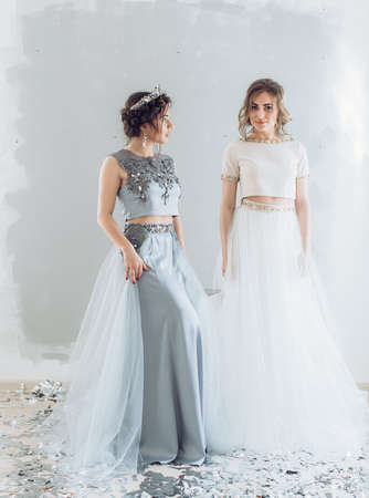 Portrait of beautiful young women with makeup in fashion clothes long dressの写真素材