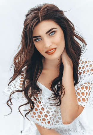 Beautiful fashion model Woman with hair, Red lipstick. Portrait of glamour girl with bright makeup. Beauty female face close up with perfect make upの写真素材