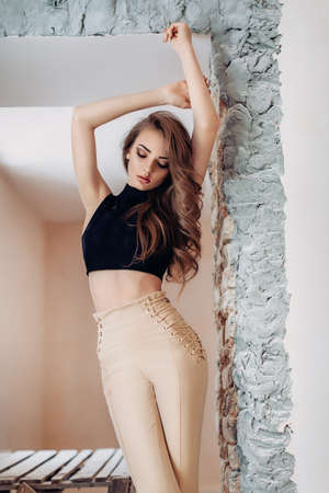 Portrait of beautiful young woman with makeup in fashion clothesの写真素材