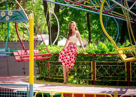 Portrait of beautiful young woman with makeup in fashion clothes in parkの写真素材