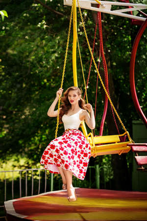 Portrait of beautiful young woman with makeup in fashion clothes in parkの写真素材