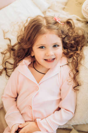 Beautiful little girl in pink dressの写真素材