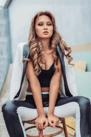 Portrait of beautiful young woman with makeup in fashion clothes