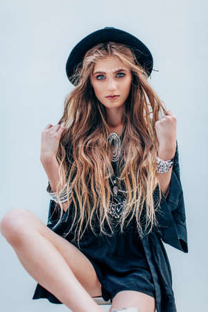 Portrait of a beautiful girl with makeup in black fashion clothesの写真素材