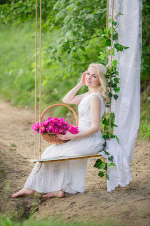 Beautiful young woman in spring gardenの写真素材