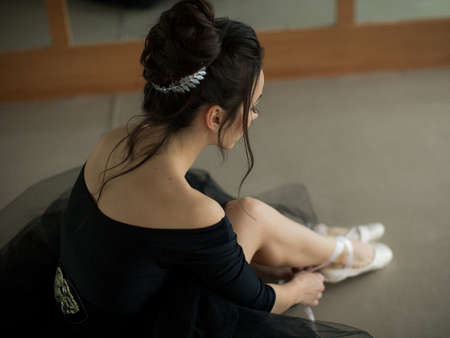 young ballerina is relaxing in class roomの写真素材