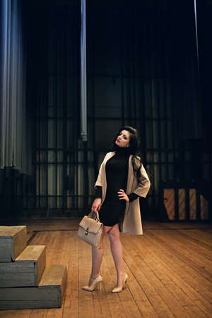 Portrait of beautiful young woman with makeup in fashion clothes