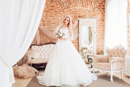 Portrait of beautiful woman with makeup in fashion wedding white clothesの写真素材