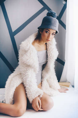 Portrait of beautiful brunette girl with makeup in fashion clothesの写真素材