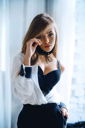 Portrait of a beautiful young girl with makeup in fashion clothes