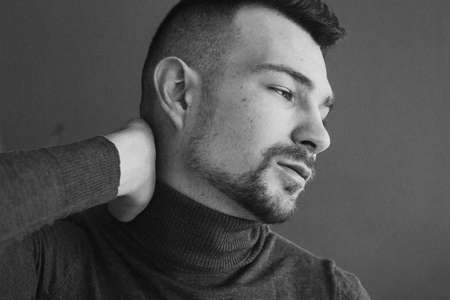 Beautiful man on a dark gray backgroundの写真素材