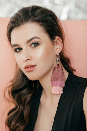 Portrait of beautiful young brunette woman with makeup