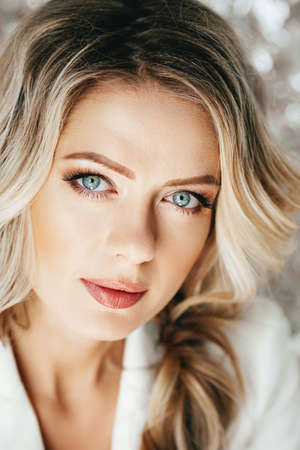 Portrait of beautiful young blonde woman with makeupの写真素材