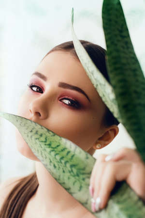 Portrait of beautiful young brunette woman with makeupの写真素材