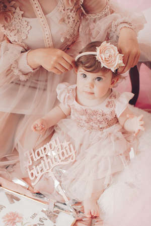 Beautiful little girl celebrating birthday party. Family celebration of the childの写真素材