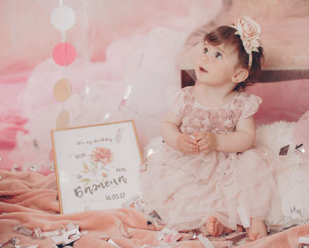 Beautiful little girl celebrating birthday party. Family celebration of the child