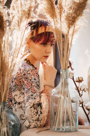 Portrait of a beautiful young girl with makeup in fashion clothes