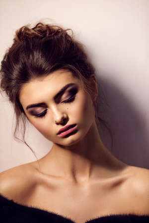 Portrait of beautiful young brunette woman with makeup