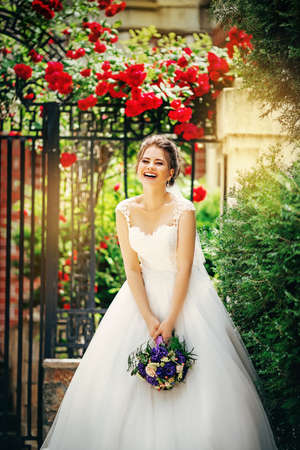 Beautiful bride in white dress in the garden