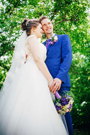 Bride and groom on their wedding day in gardenの写真素材