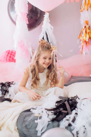 Beautiful little girl celebrating birthday party with big bouncy balls. Family celebration of the childの写真素材