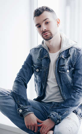 Beautiful man on a gray backgroundの写真素材