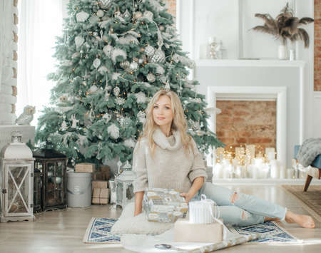 Happy blonde women in Christmas decorationsの写真素材