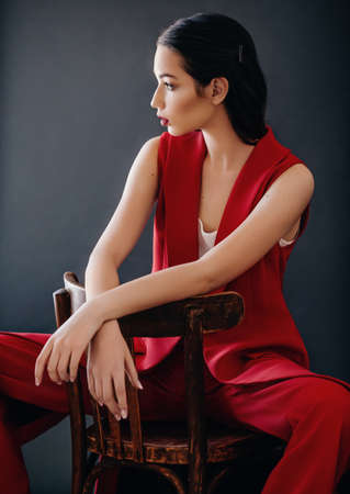 Beautiful brunette girl in fashion red clothesの写真素材