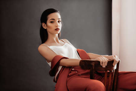 Beautiful brunette girl in fashion red clothes